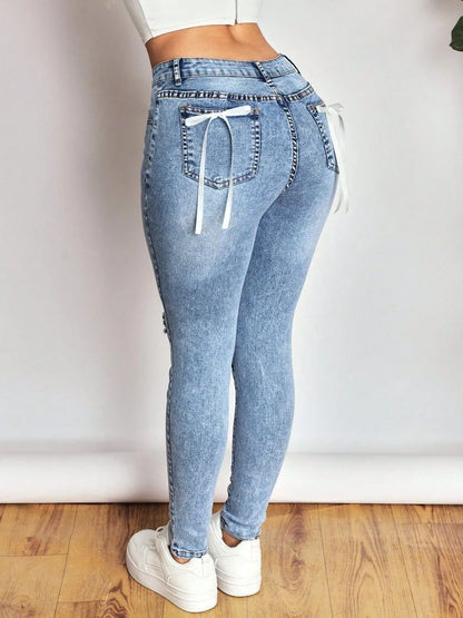 distressed skinny jeans with bow back